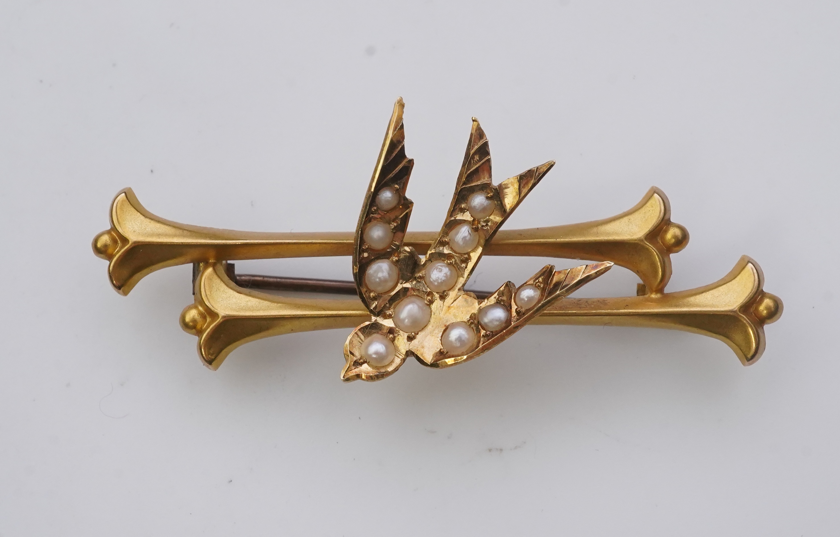 A collection of three brooches and a pendant, 19th and 20th century